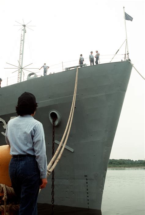 A Sailor Waits For The Signal To Remove A Mooring Line Securing The