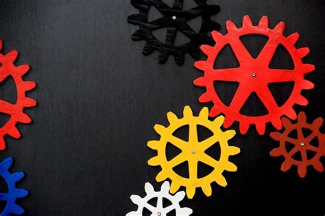 Premium Photo Colorful Wooden Gears On A Black Background Space For