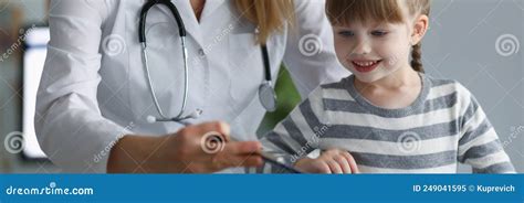 Pediatrician Female Try To Distract Child Attention And Make Diagnostic