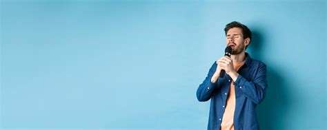 Free Photo Romantic Guy Singing In Microphone Performing On Stage