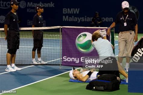 Petra Martic of Croatia is given assistance after injury during her... News Photo - Getty Images