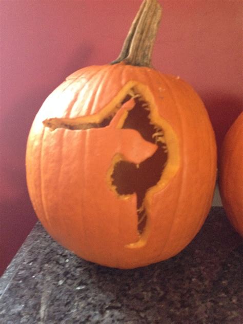 Two Carved Pumpkins Sitting On Top Of A Counter