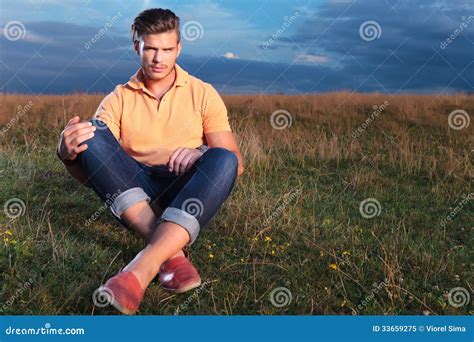 Casual Man In The Grass Holding His Knees With Hands Stock Image Image Of Model Late 33659275