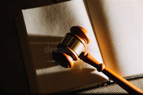 Law Books And Scales Of Justice On Desk In Library Of Law Firm