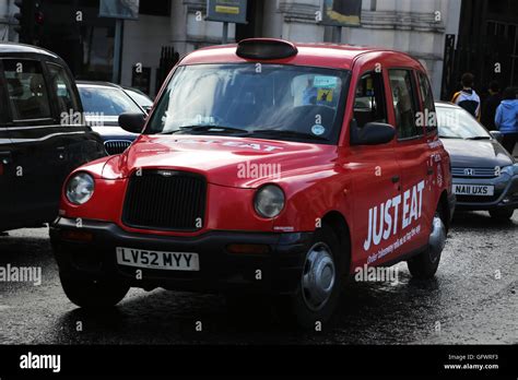 London England Red Taxi Advert Just Eat Stock Photo Alamy