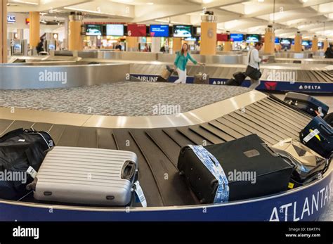 Baggage Claim Carousel And Airline Passengers At Hartsfield Jackson