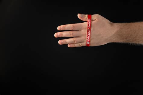 Premium Psd Hand Wearing Red Bracelet With Dark Background