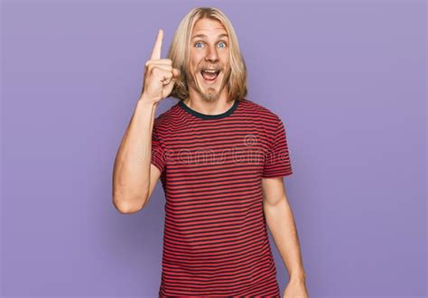 Caucasian Man With Blond Long Hair Wearing Casual Striped T Shirt