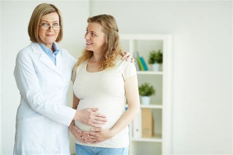 Free Photo Doctor Touching The Belly Of Her Patient