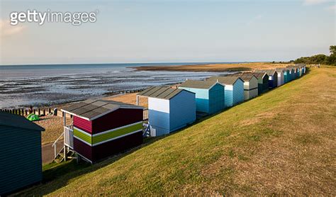 Colourful Wooden Beach Huts Facing The Ocean At Whitstable Coast Kent