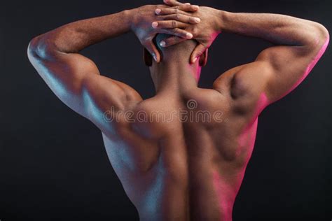 African Male Athlete With Naked Torso Posing Against Dark Wall Low Key Photo Stock Image