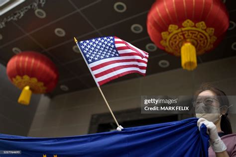 TOPSHOT - A protester holds a US flag outside of the Chinese... News ...