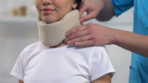 Doctor Applying Female Patient Foam Cervical Collar On Neck Comfort Medicine Stock Video