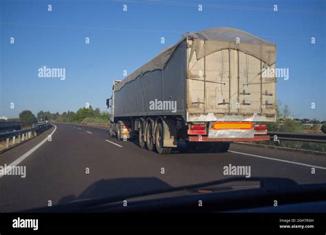 driving  net covered trailer truck view