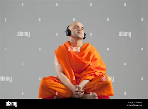 Monk listening to music Stock Photo - Alamy