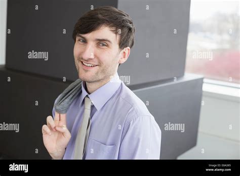 Portrait Of Businessman Holding Suit Smiling Stock Photo Alamy