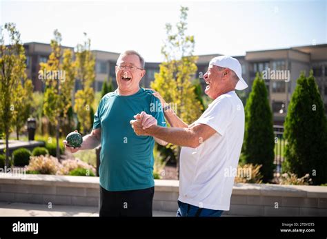 Seniors playing games outdoors Stock Photo - Alamy