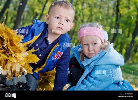 Young Children Playing In An Autumn Woodland Stock Photo Alamy