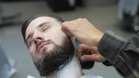 Barber Uses Straight Razor To Shave Mans Neck And Face To Shape Facial