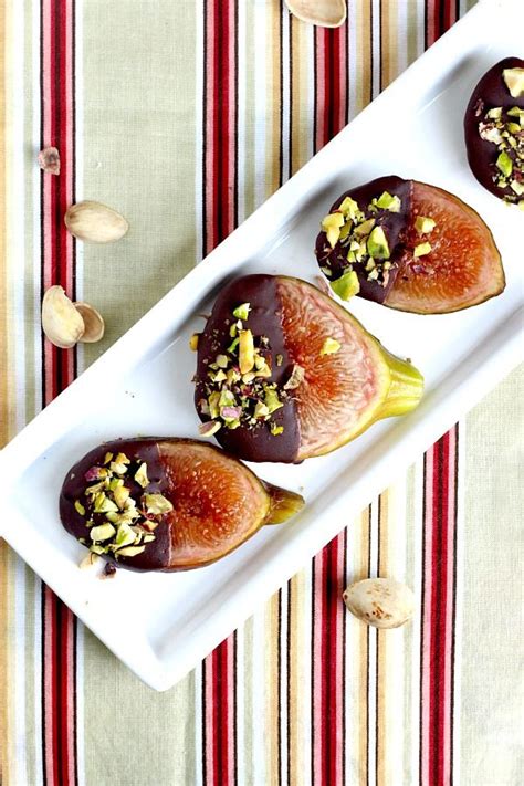 Three Pieces Of Fruit On A Plate With Nuts And Pistachios Around Them