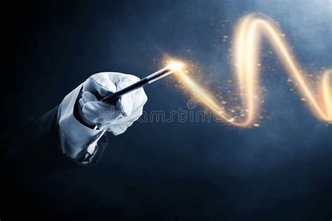 Magician Hand Holding Magic Wand on Dark Backgrounds Stock Image ...