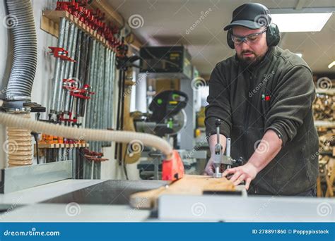 Carpenter Cutting Wood By Using A Table Saw In His Studio Handicraft