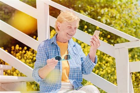 Premium Photo Mature Woman Sitting Alone On The Terrace Of Beach Cafe