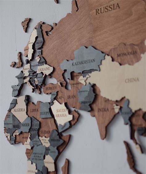 The World Map Is Made Out Of Wood And Has Countries Marked In Different