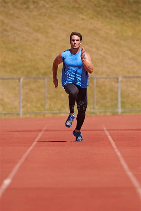 Holding Nothing Back Action Shot Of A Young Male Athlete Running On A