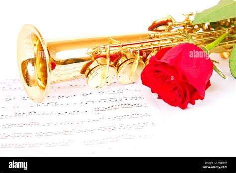 Pink Rose Saxophone And Music Sheet On A White Background Stock Photo