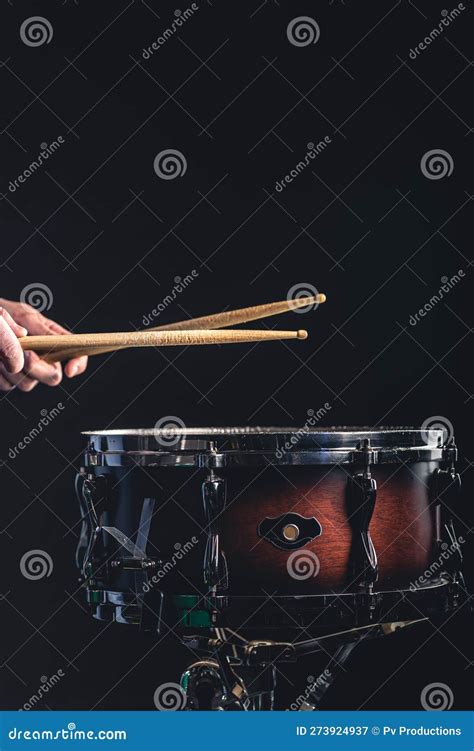 A Man Plays The Snare Drum Against A Dark Background Stock Image