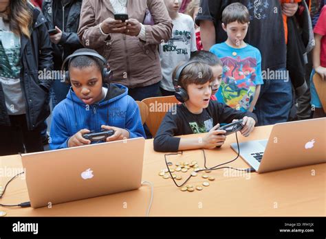 Children playing video games on Apple Powerbook laptop computers - USA ...