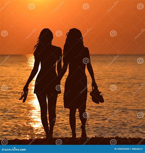 Silhouette Of Two Lesbian Girls On The Beach In Sunset Stock