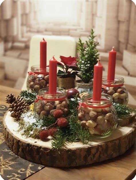 A Wooden Table Topped With Lots Of Candles And Christmas Decorations On