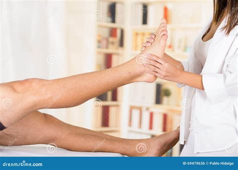 Female Physio Therapist Hands Working On Male Patients Lower Leg And