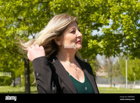 Happy Mature Blonde Woman Walking On The Park Stock Photo Alamy