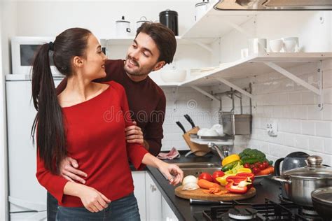 Young Couple Having Romantic Evening At Home In The Kitchen Cooking