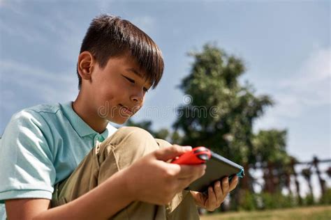 Focused Multiethnic Boy Playing On Game Console Stock Image Image Of