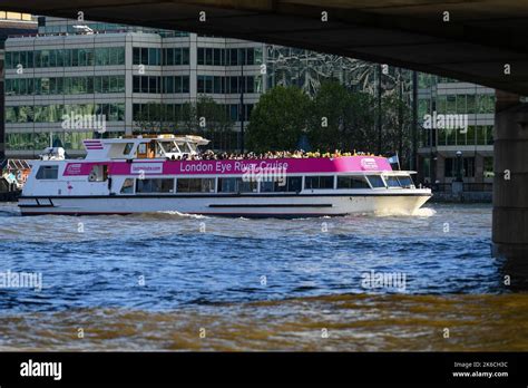 The London Eye River Cruise Boat Travels Down The Thames Under London