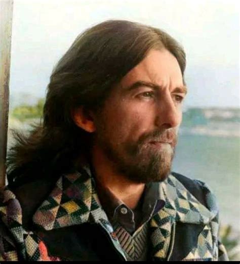 A Man With Long Hair Wearing A Jacket And Looking Off Into The Distance