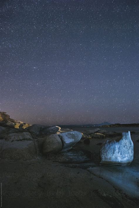 "Night Sky With Stars Above The Rocky Beach" by Stocksy Contributor "B Krokodil" - Stocksy