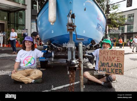 Two Members Of Extinction Rebellion DC Sit Chained To A Boat Outside