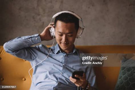 Asian Man Listening Music Photos And Premium High Res Pictures Getty