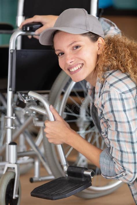 Woman Making Adjustment On Wheelchair Stock Photo Image Of Adjust