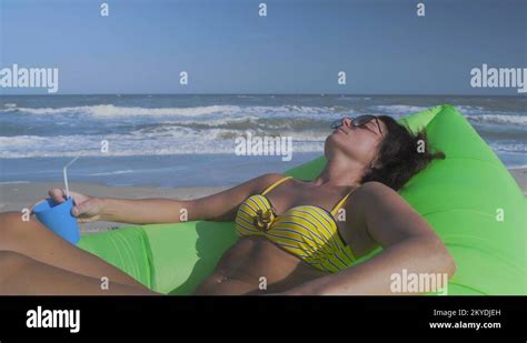 Close Up Beautiful Woman In Bikini Sunbaths On Sea Beach Lies On Green Stock Video Footage Alamy