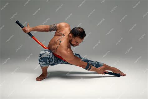 Premium Photo | A ninja man holds on to a fighting stick and attacks ...