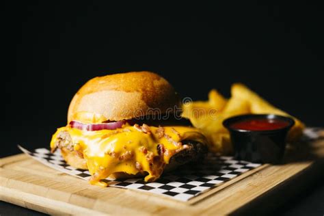 Cheese Burger Topped With Bacon Over A Black Background Stock Photo