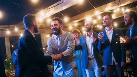 Handsome Happy Gay Couple Celebrate Wedding At An Evening Reception Party With Diverse