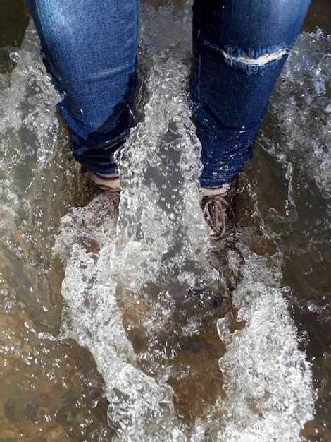 Premium Photo Low Section Of Person Standing In Sea