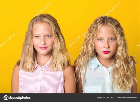 Emotional Pretty Teenage Twins Girls With Blonde Hair Amazing Eyes And Clean Skin Stock Photo